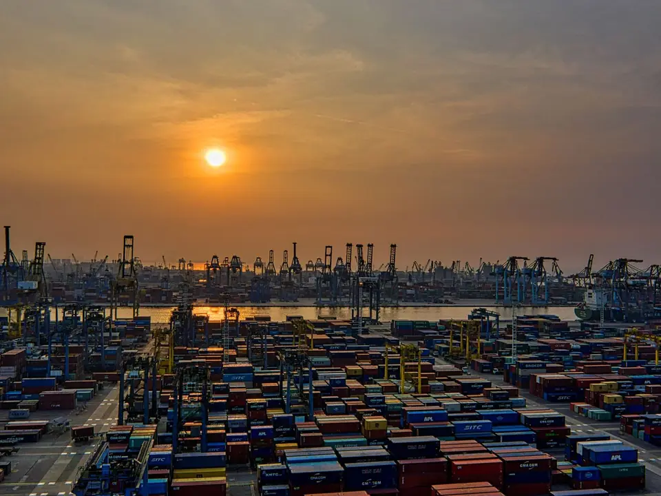 Container terminal and cranes at sunset